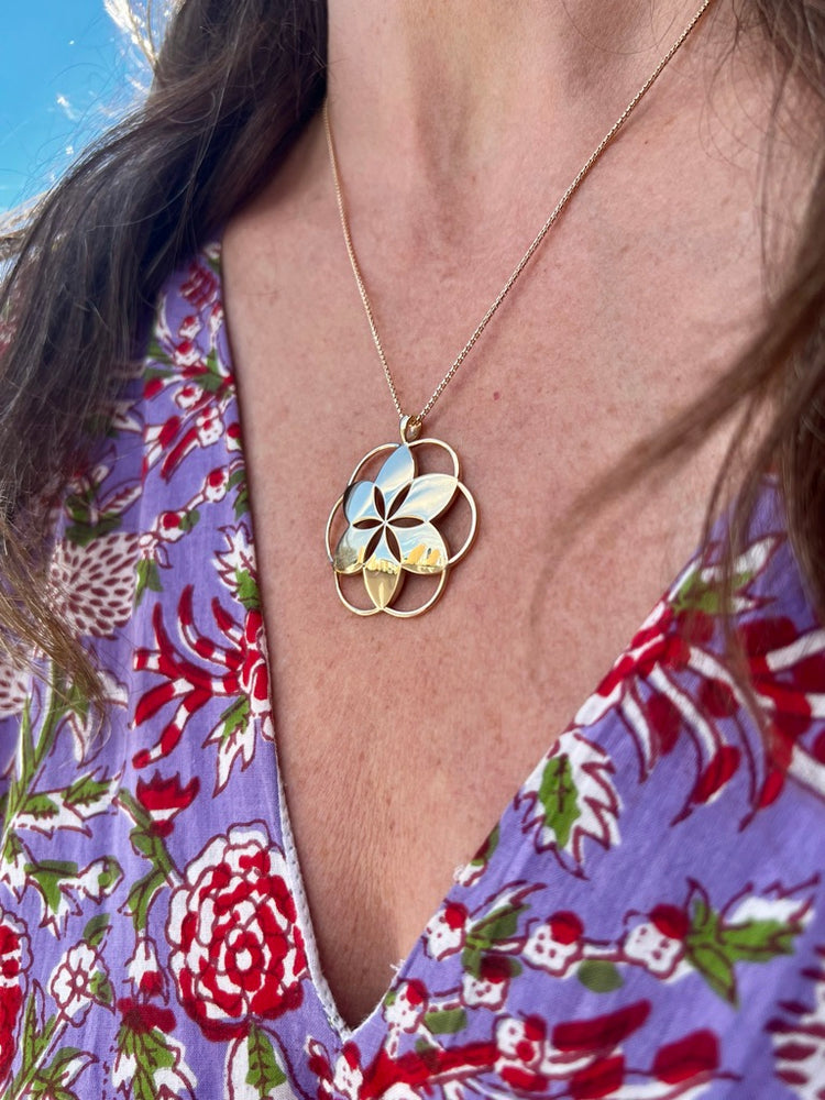 wearing Hannah Daye signature Rosette Pendant in solid 14k gold on an 18" chain beautiful style timeless design original