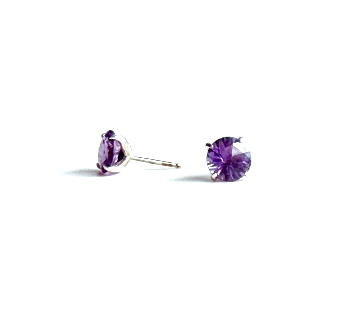 Pair of purple stud earrings on a white background