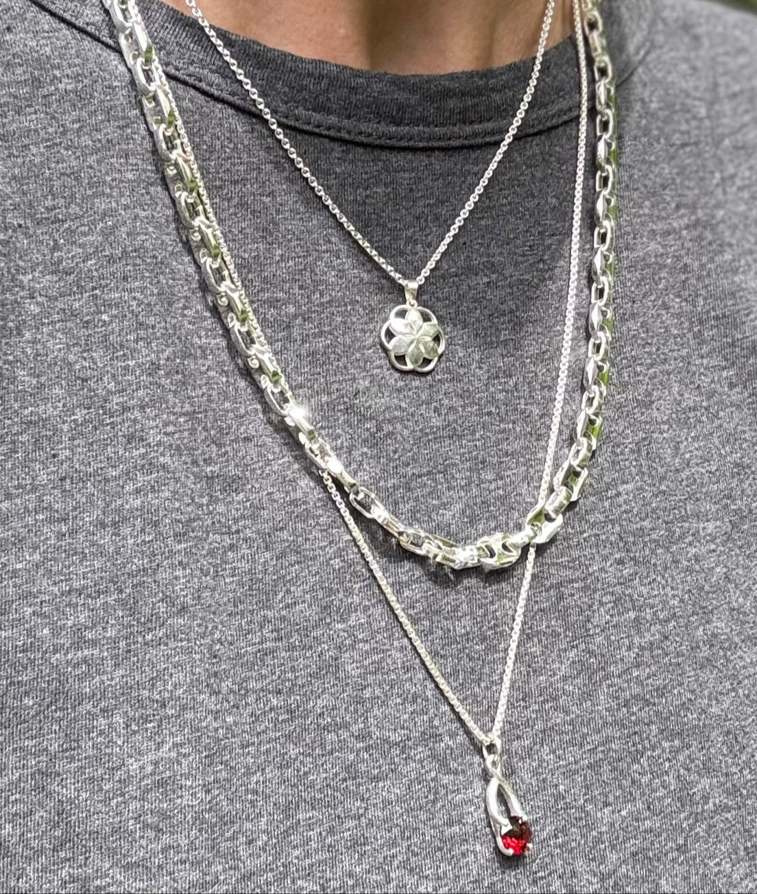 Garnet Brillante Charm Pendant layered wit hMariner Necklace and Rosette Piccolo Pendant all by Hannah Daye