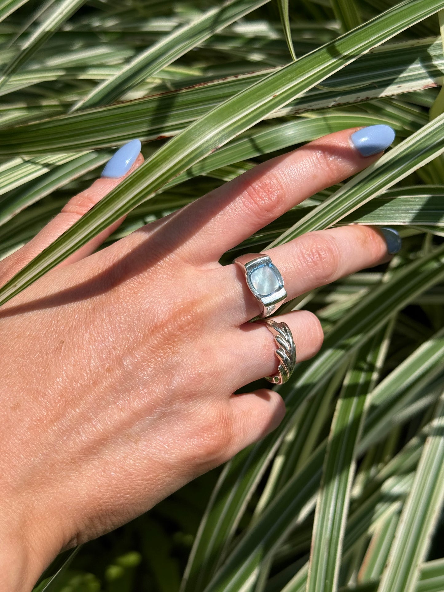 wearing Milan Piccolo Ring Sky Blue Topaz and Palm Leaf Ring both by Hannah Daye & Co shown in the grasses