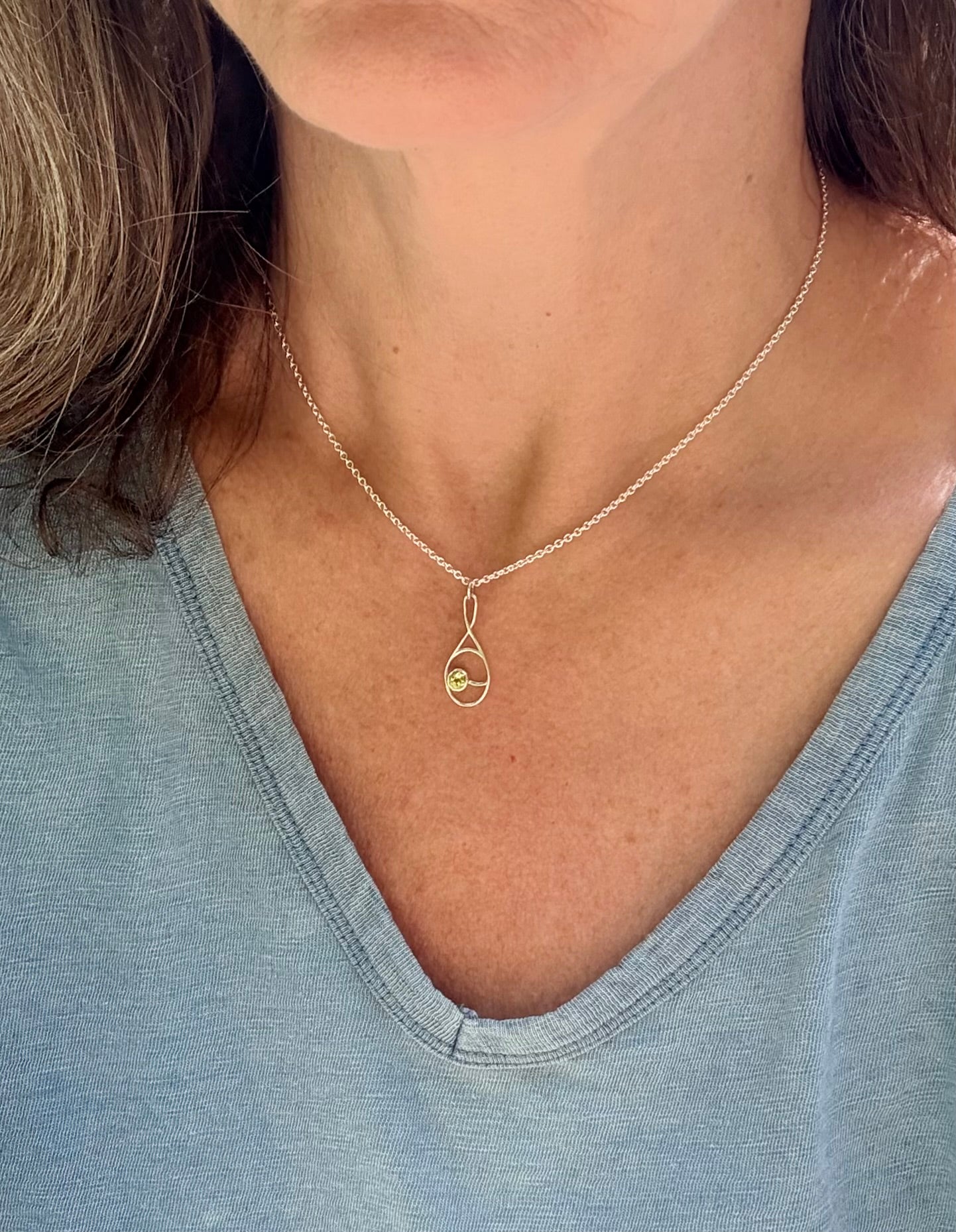 wearing Deuce Tennis Pendant with Peridot by Hannah Daye original design