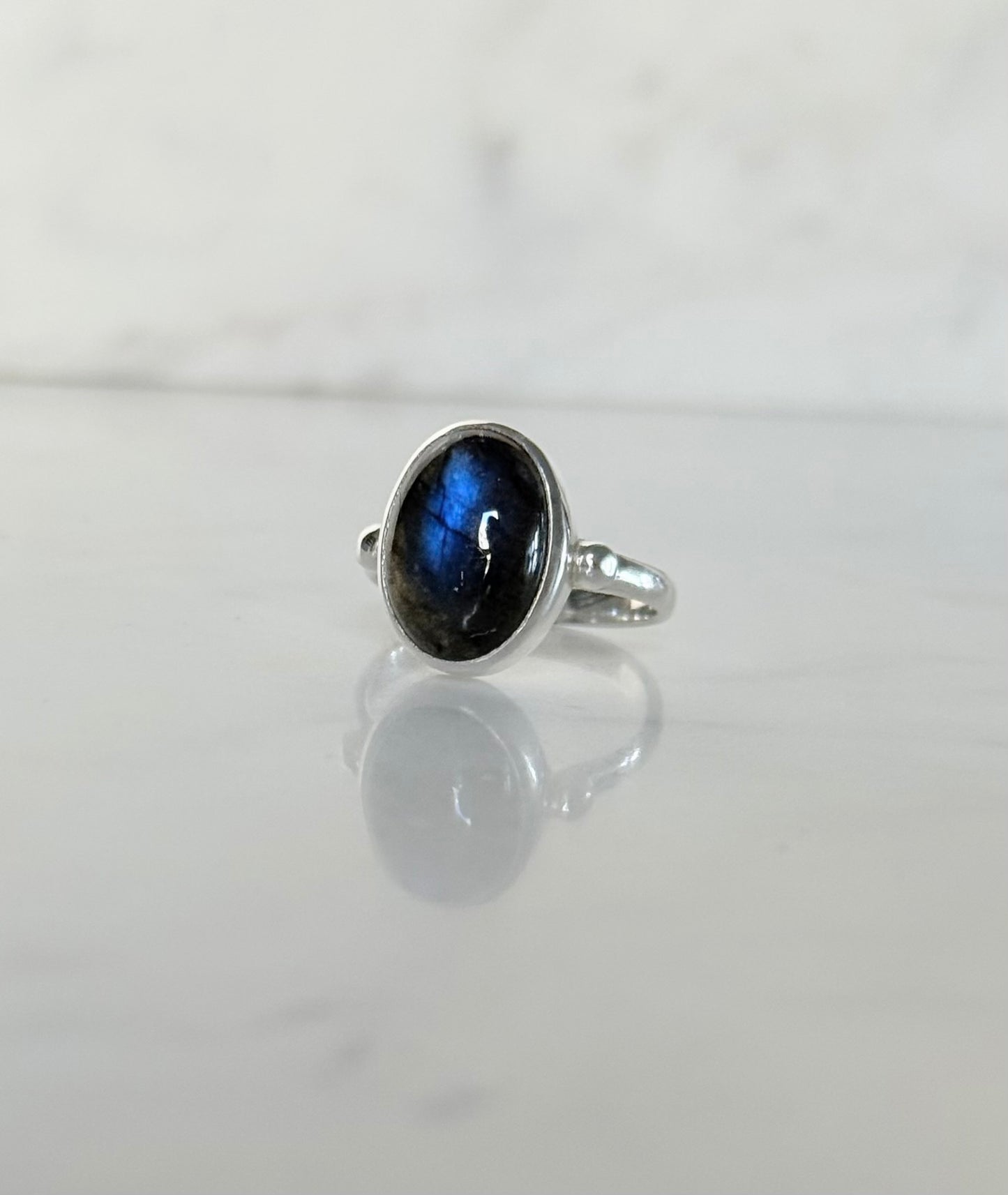 Windsor Ring sterling silver with blue labradorite hand crafted sitting on marble counter