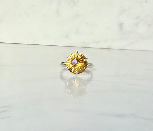 Citrine front view Sterling silver ring by Hannah Daye on smooth stone surface