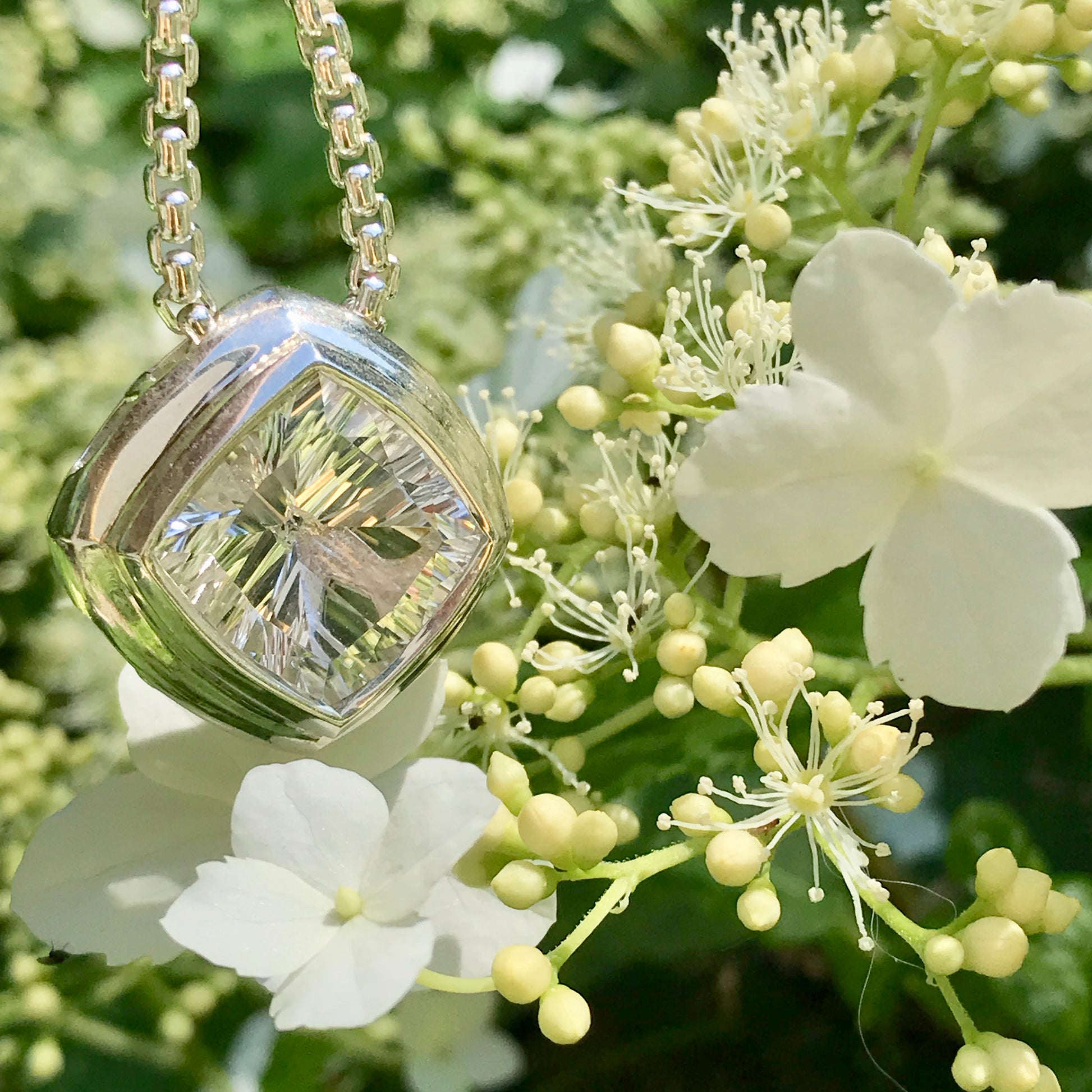 Concord Cushion Pendant by Hannah Daye shown with Hydrangea