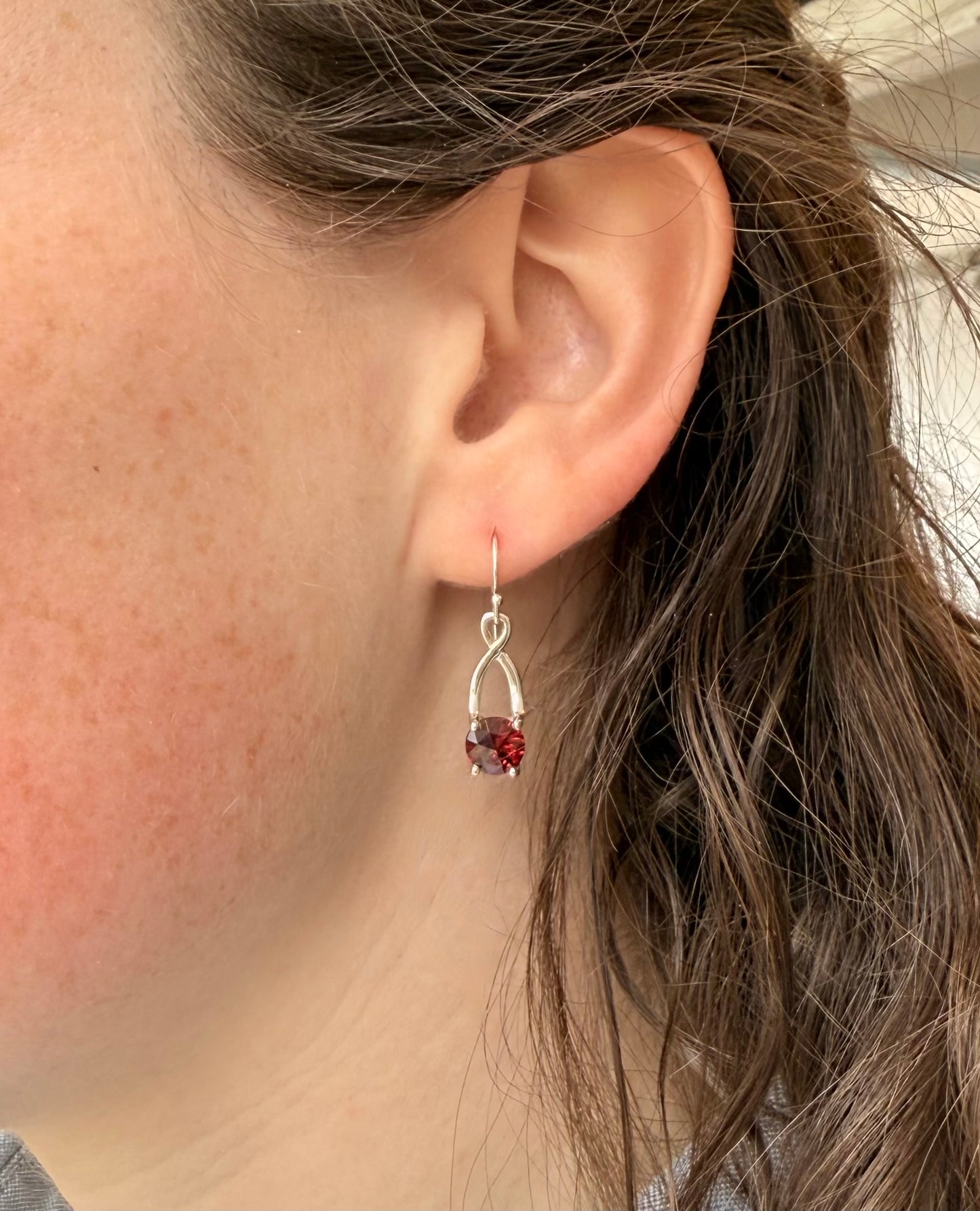 wearing garnet drop sterling silver earrings