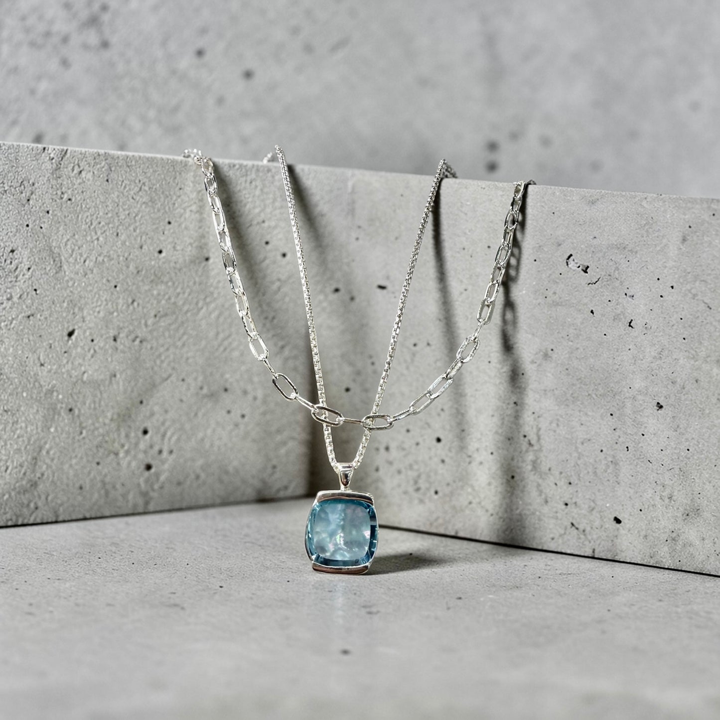 Paperclip Piccolo Necklace shown layered with Milan Sky Blue Topaz Pendant both by Hannah Daye & Co