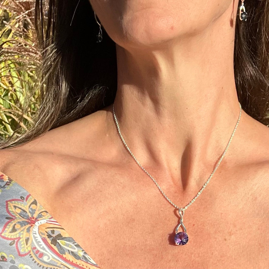 Wearing Amethyst Brillante Pendant and London Blue Brillante Earrings all by Hannah Daye