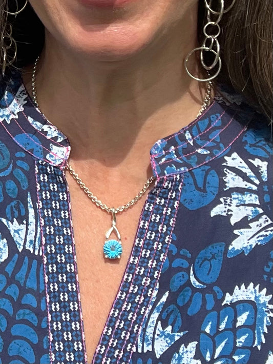 wearing Brillante Swiss Blue Topaz pendant on 17" sterling chain and shwon with Saturn Double Earrings allby Hannah Daye