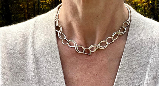wearing sterling silver equestrian necklace with infinity links  by Hannah Daye & Co