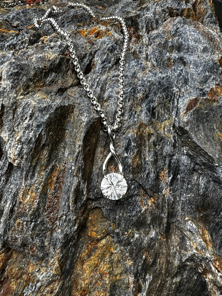 Brillante White Pendant by Hannah Daye fine jewelry shown on the rocks