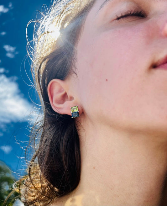 wearing Peridot and London Blue Topaz emerald cut gemstones earrings by Hannah Daye & Co fine jewelry original design hand made 