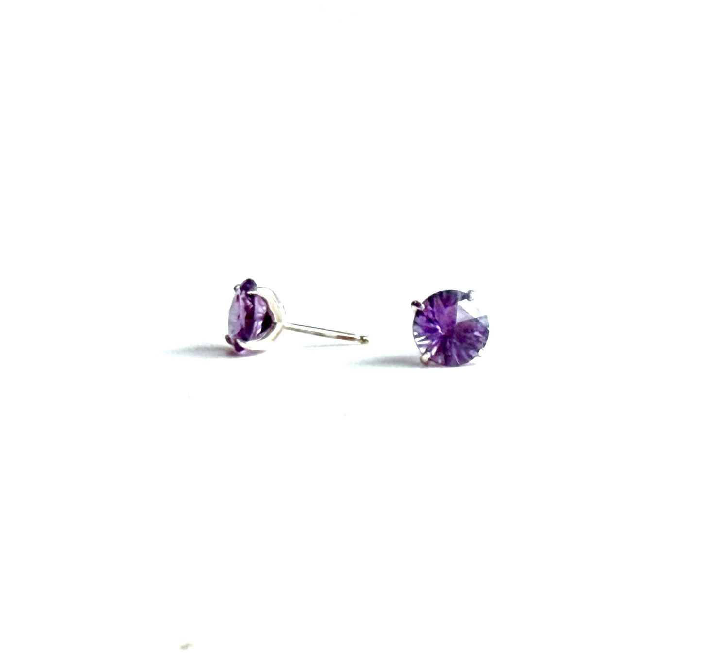 Pair of purple stud earrings on a white background