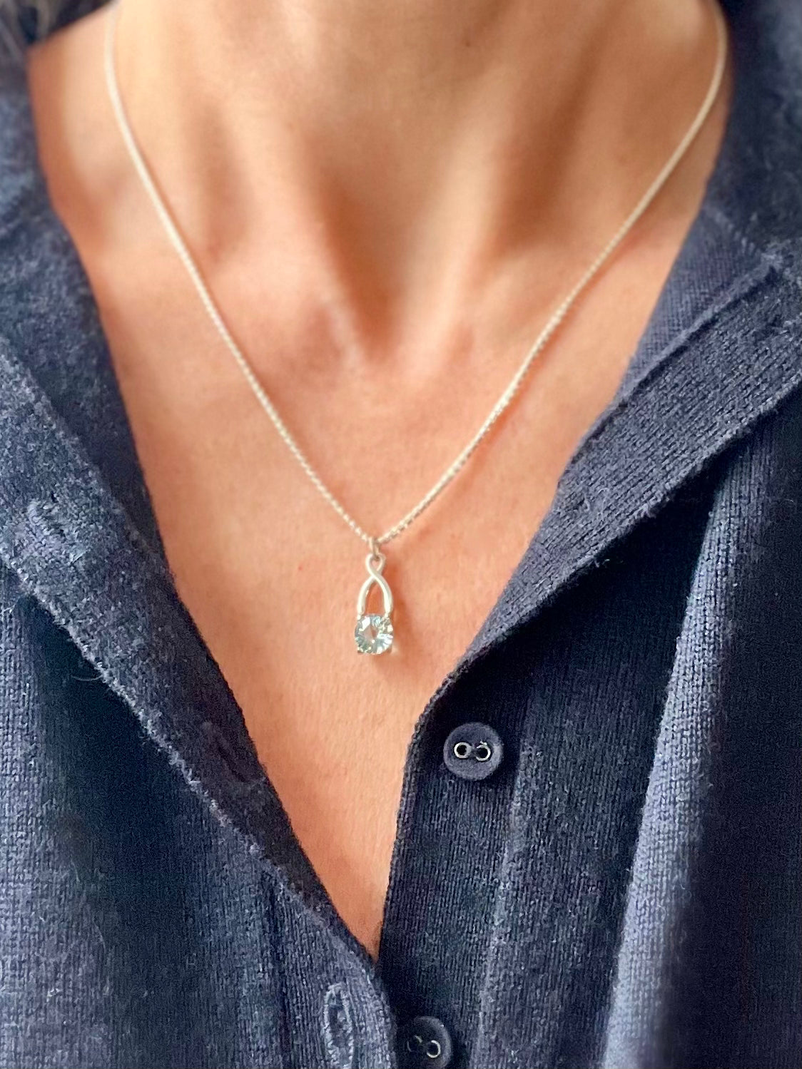 wearing Brillante Charm pendant Sky Blue Topaz by Hannah Daye fine jewelry