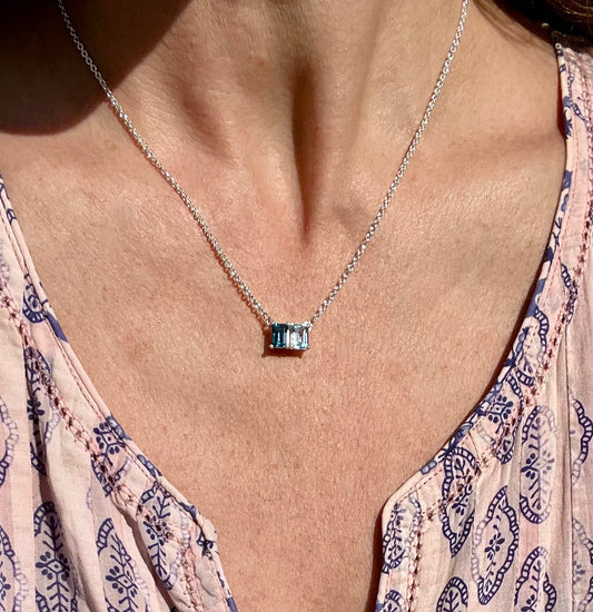 wearing Lexington Sterling Silver necklace in Sky Blue Topaz and London Blue Topaz by Hannah Daye & Co