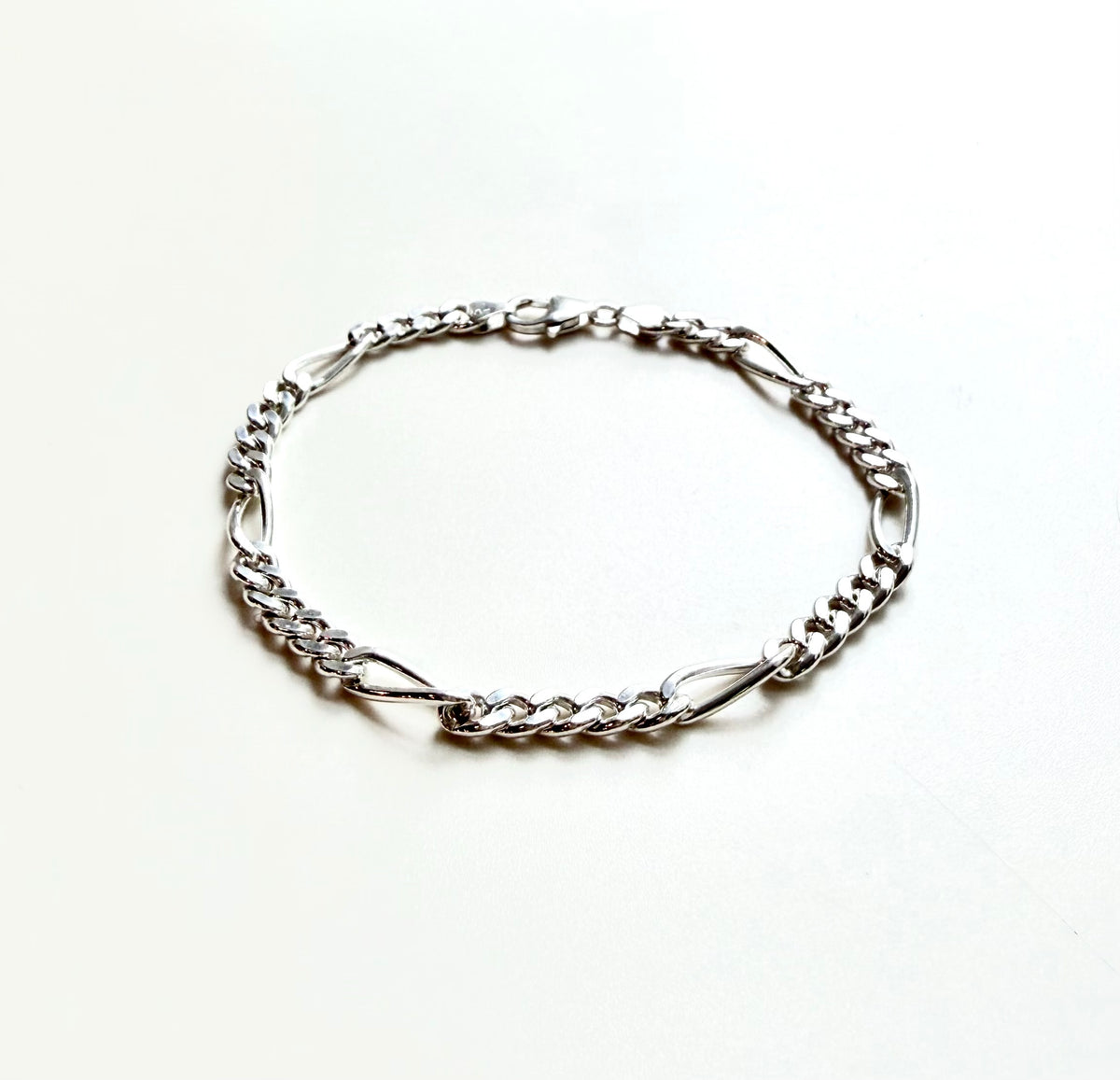 sterlign silver hcain link bracelet on white background