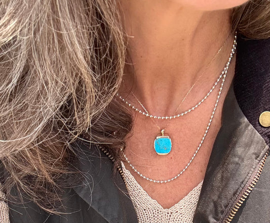 wearing Milan Pendant 14k yellow gold in Turquoise with Sterling Silver Bead Chain necklace all by Hannah Daye & Co original design