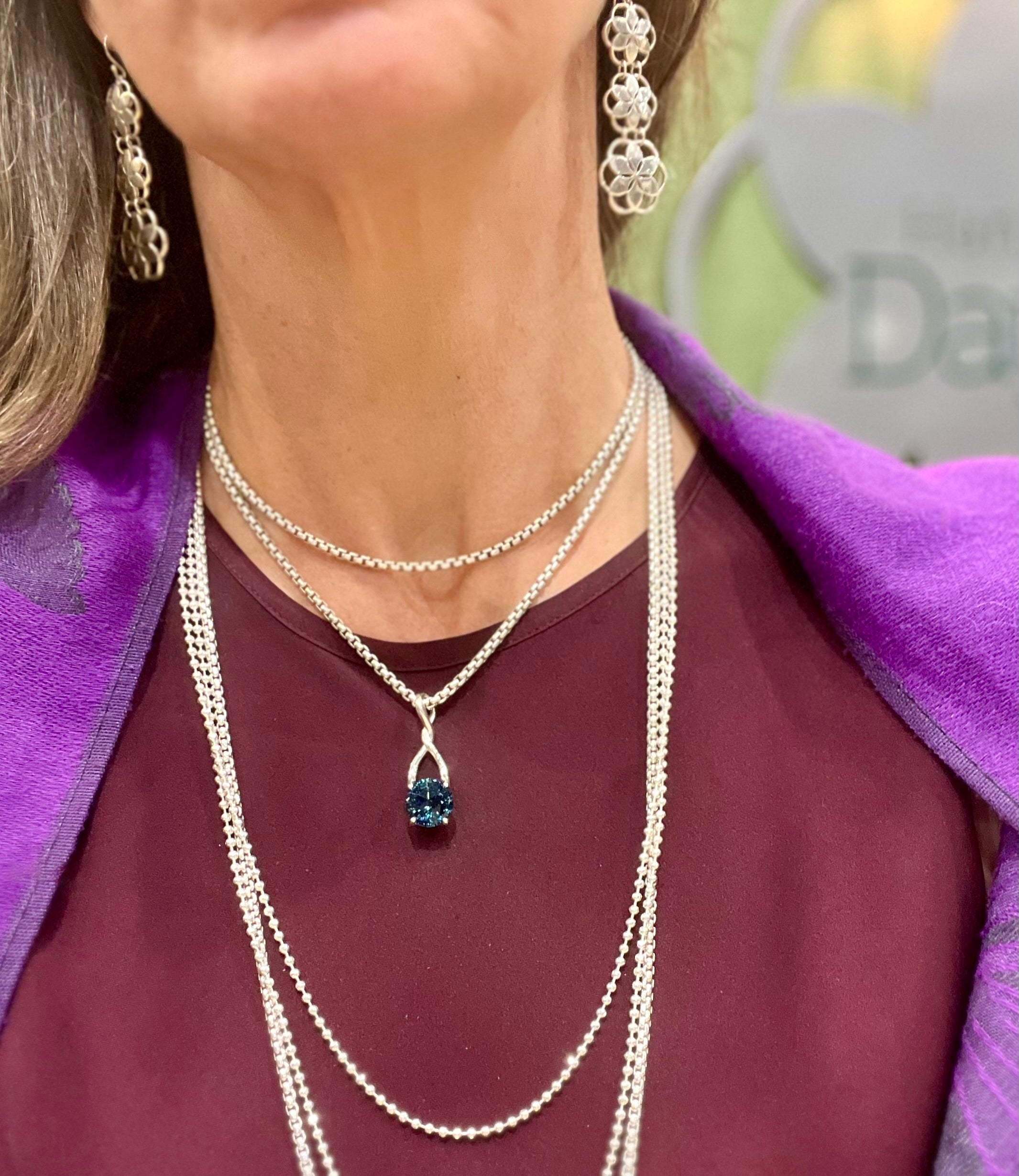 wearing London Blue Topaz Brillante Pendant layered with Bead Chain and Venetian Sterling Necklaces also with Rosette Chandeliers all by Hannah Daye & Co