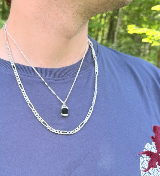 wearing Figaro necklace sterling silver layered with Milan Charm pendant in Black Onyx all by Hannah Daye mens jewelry