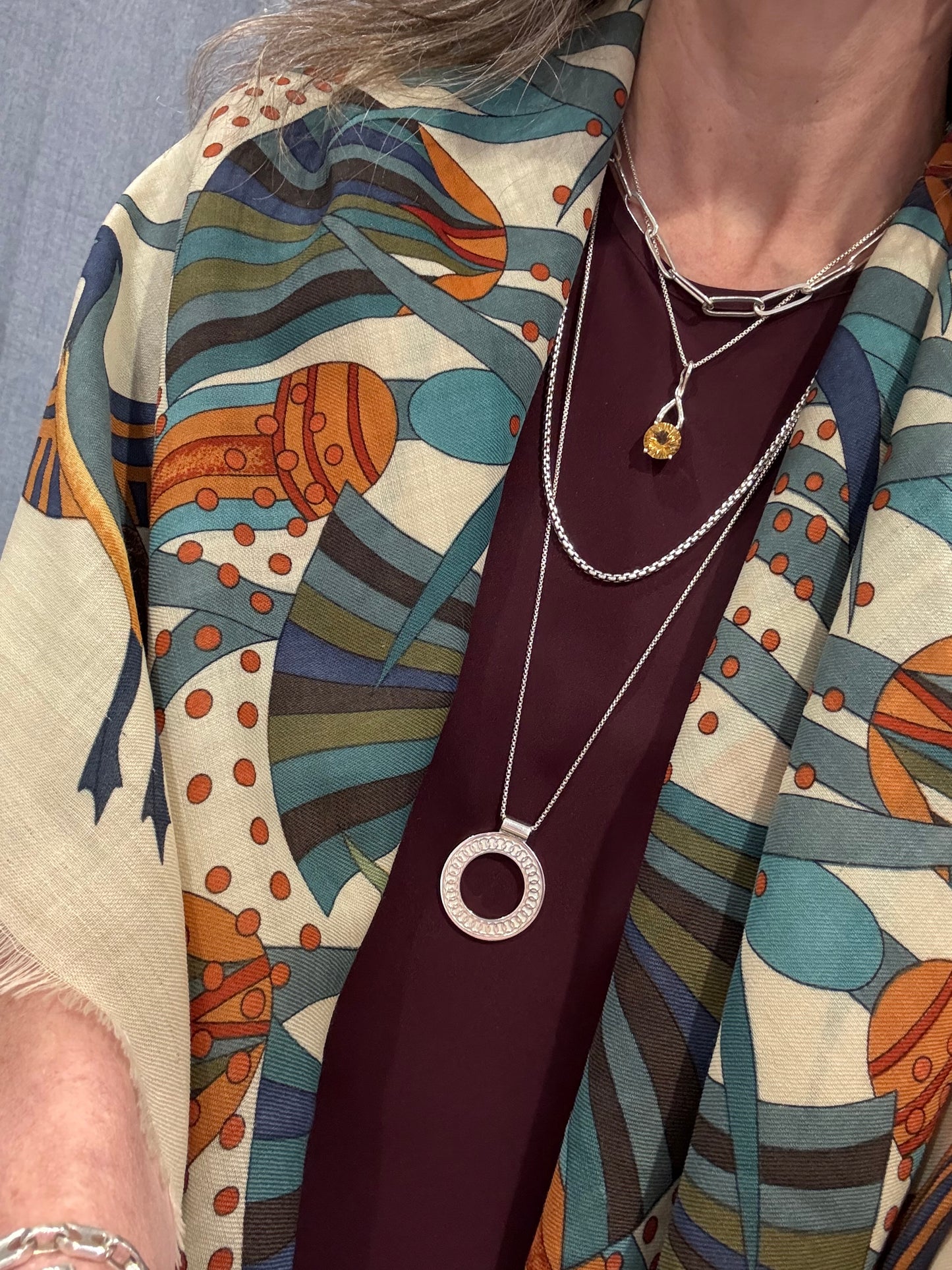 wearing Oslo Pendant layered with Citrine Brillante Pendant and Paper-clip necklace and venetian medio necklace all by Hannah Daye & Co sterling silver