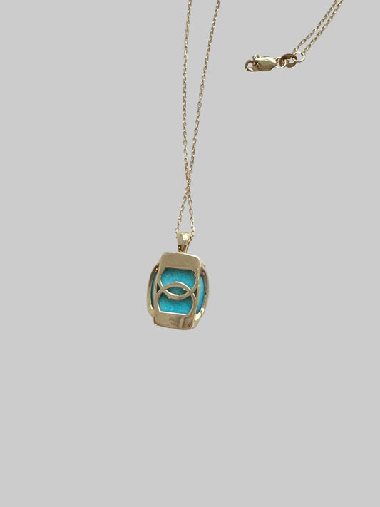 Necklace with a pendant featuring a blue stone on a light gray background