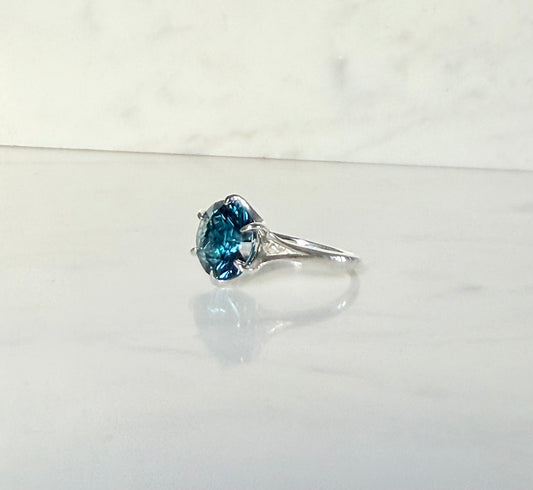 side view of London Blue Topaz Sterling silver ring by Hannah Daye on White Smooth Surface