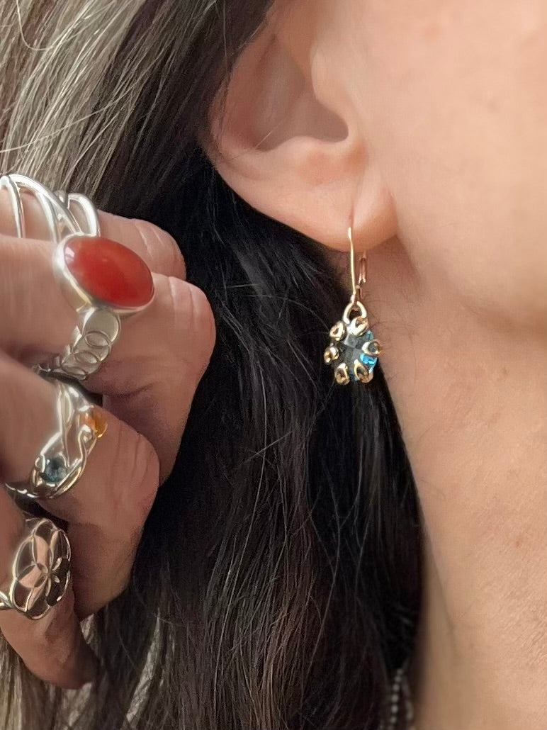 Poppy 14k gold drop earrings with London Blue Topaz shown with various sterling silver rings all by Hannah Daye & Co original design hand-crafted fine jewelry