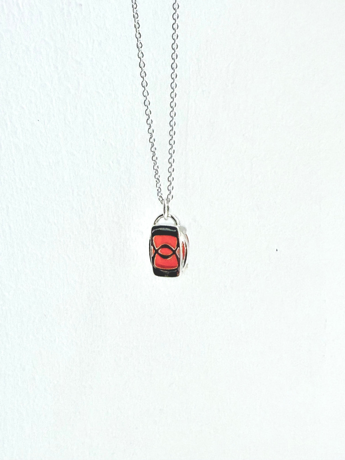 reverse side of sterling pendant with red gemstone