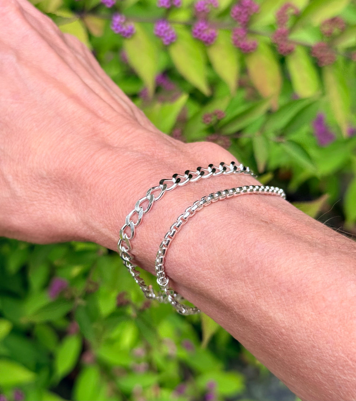 closeup of two silver bracelet