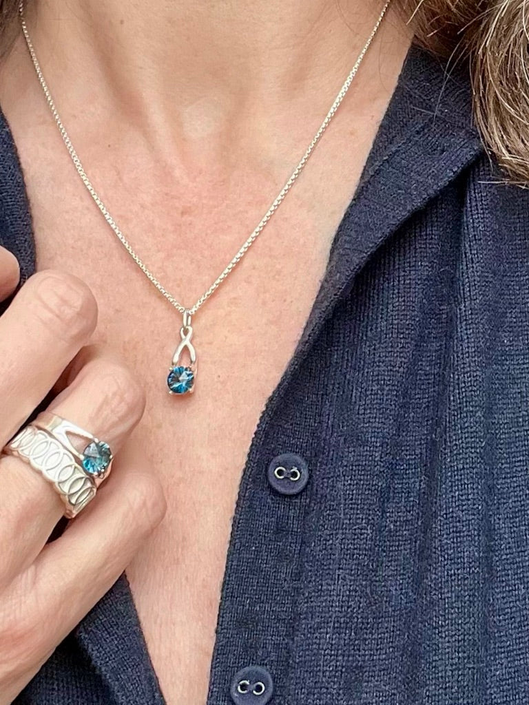Brillante Ring stacked with Oslo Band and shown with Brillante Charm all by Hannah Daye & Co