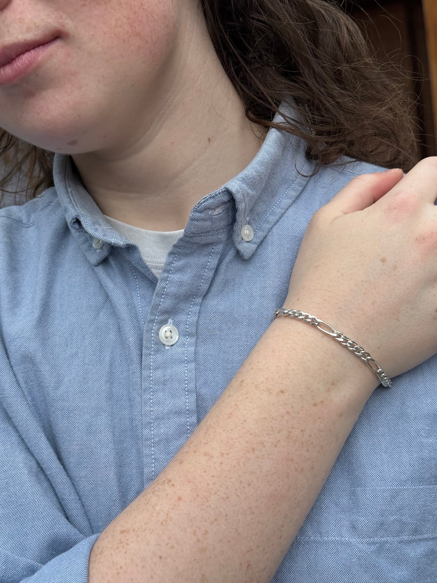Person wearing a silver bracelet