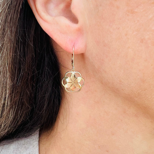 wearing Rosette petite dangle earrings in 14k yellow gold by Hannah Daye