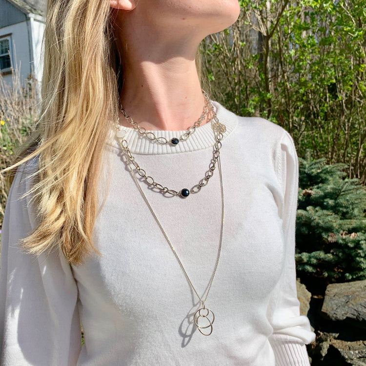 Saturn pendant layered with Cascade Infinity necklace Hannah Daye & Co