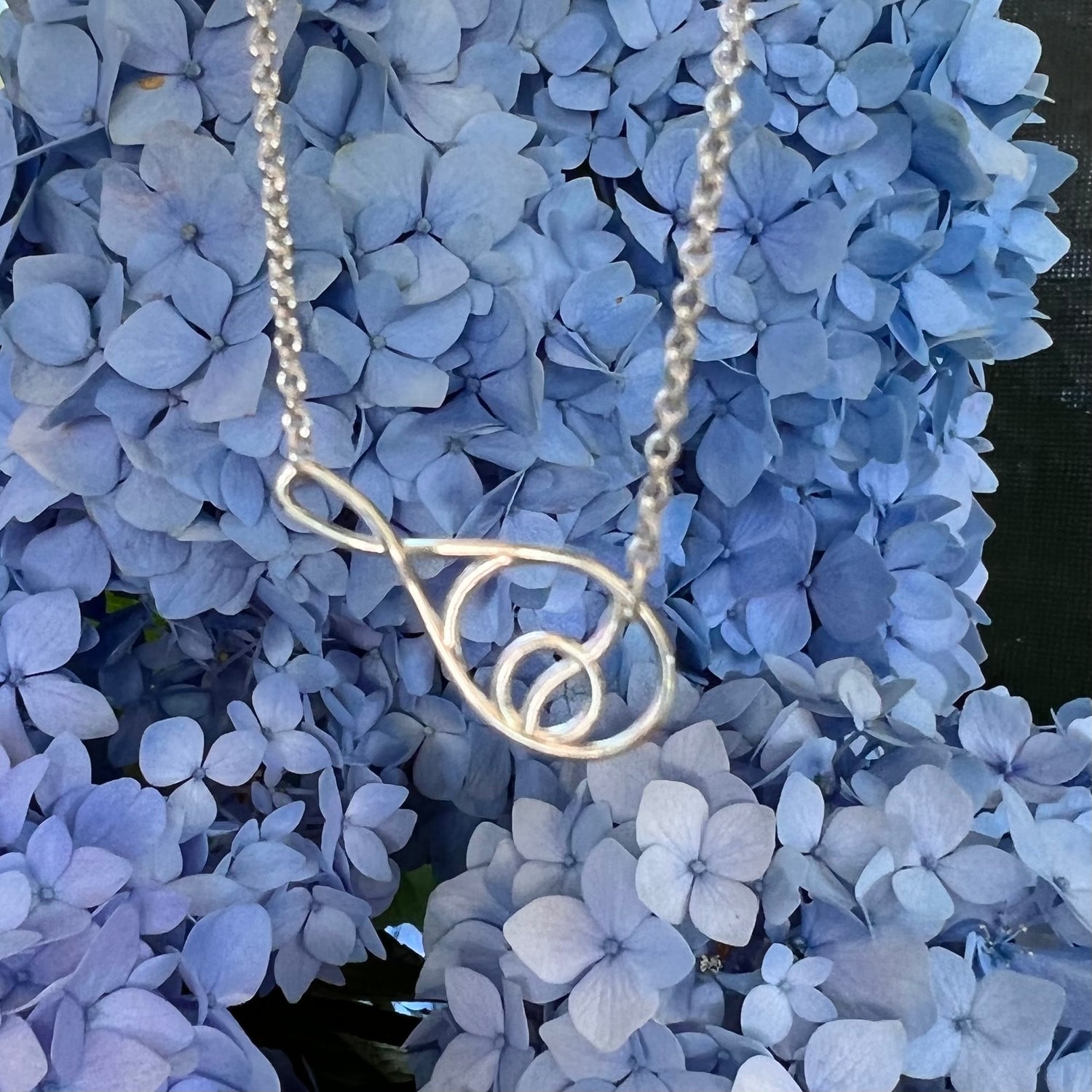 Deuce Tennis Sterling Silver Necklace shown with Hydrangea by Hannah Daye & Co