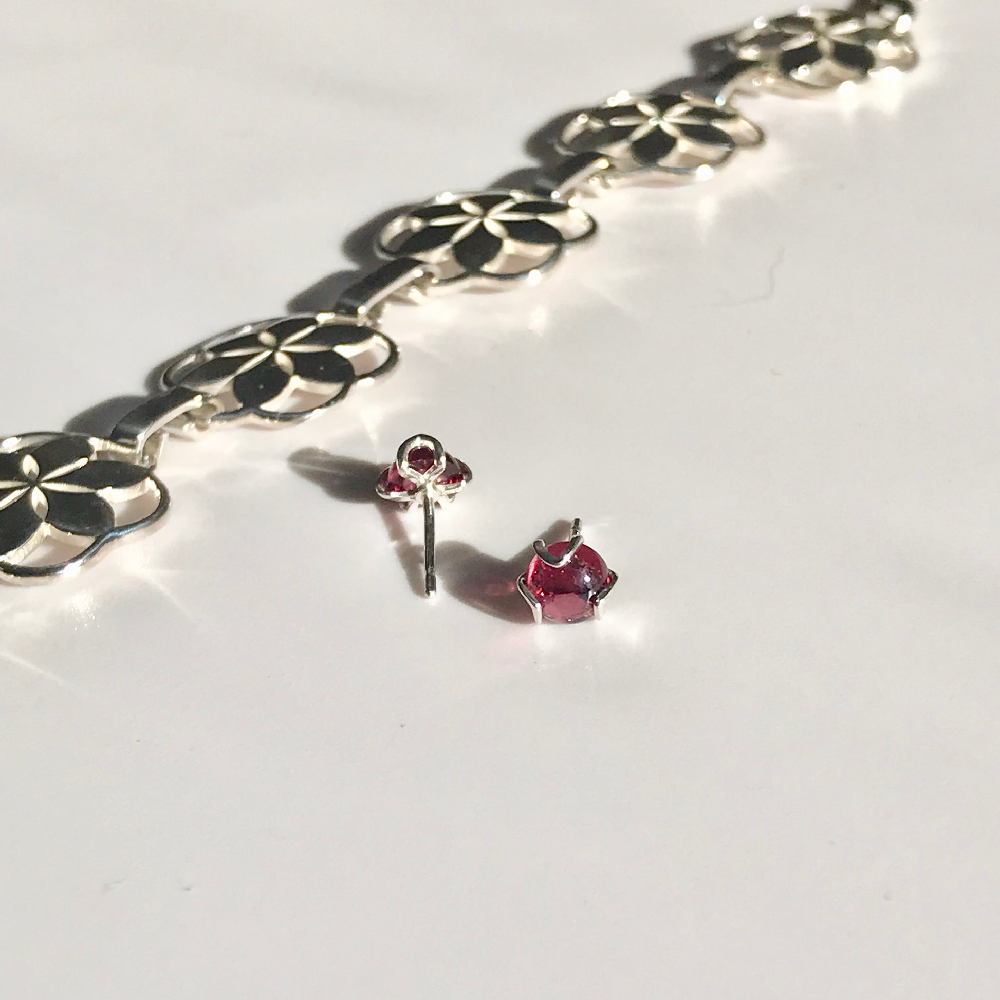 Rosette link bracelet with Fiore Garnet studs Hannah Daye & Company